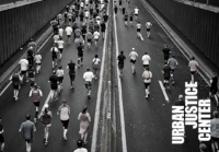 Image of New York City marathon runners on a bridge.