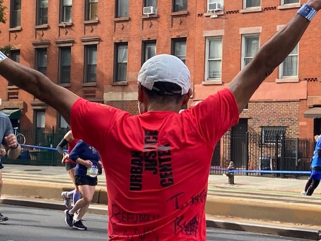 Runner shows off UJC marathon shirt